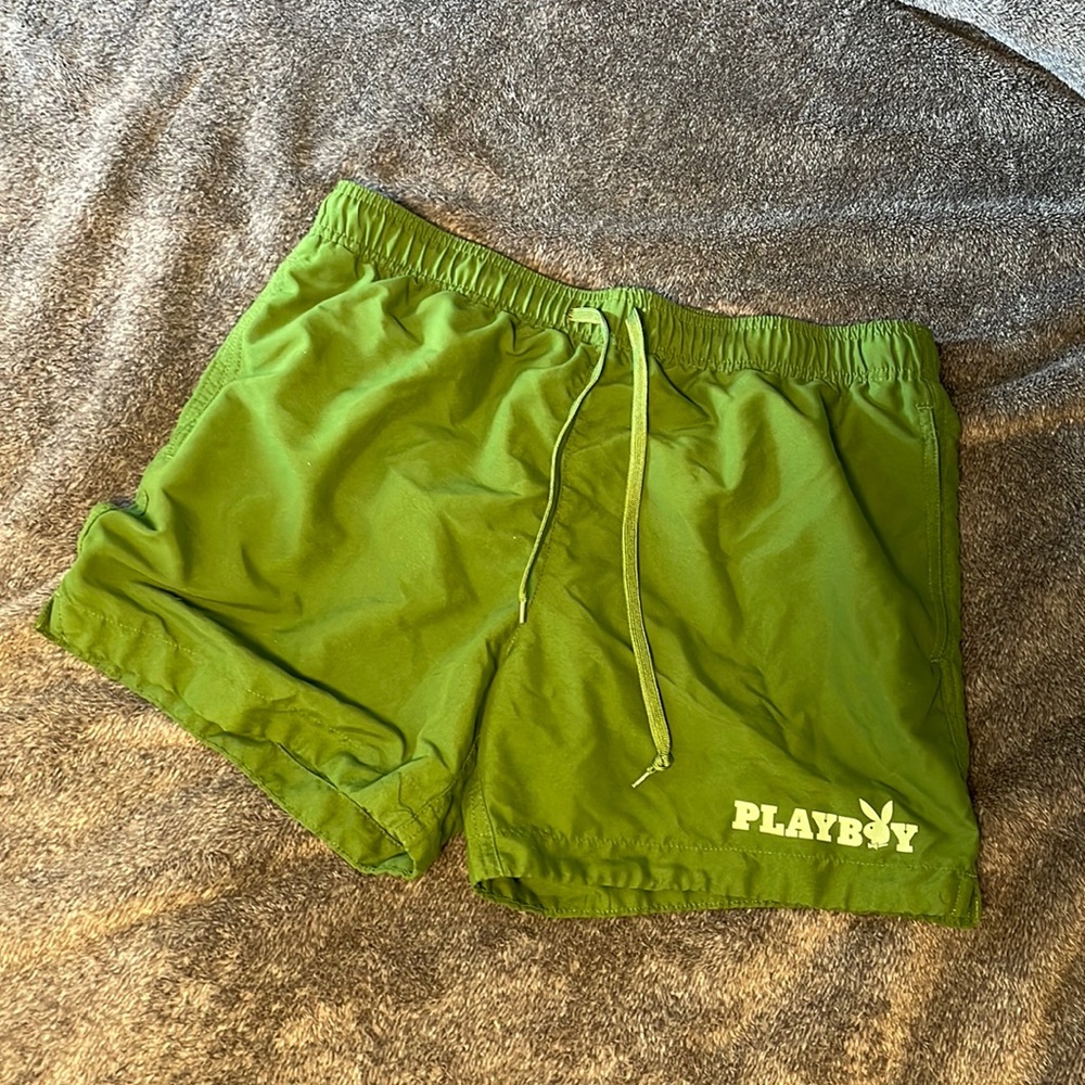 Green PLAYBOY swim trunks.